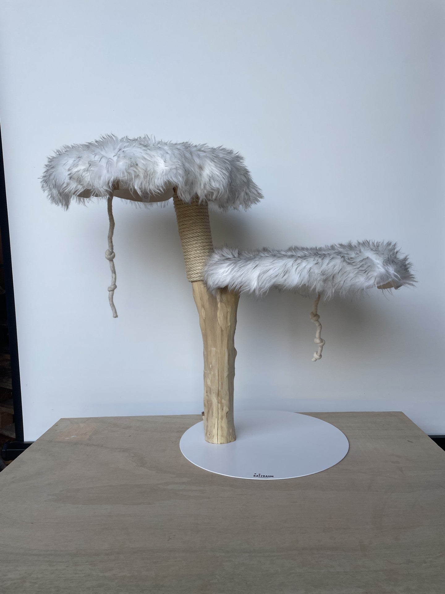 Exklusiver Naturkratzbaum im Luchs-Design mit weiß-grau geflecktem Fell. Handgefertigtes Unikat aus Echtholz mit 50cm Metallbasis für sicheren Stand.